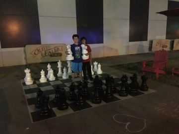 two boys playing giant chess on street of Niagara town, New York