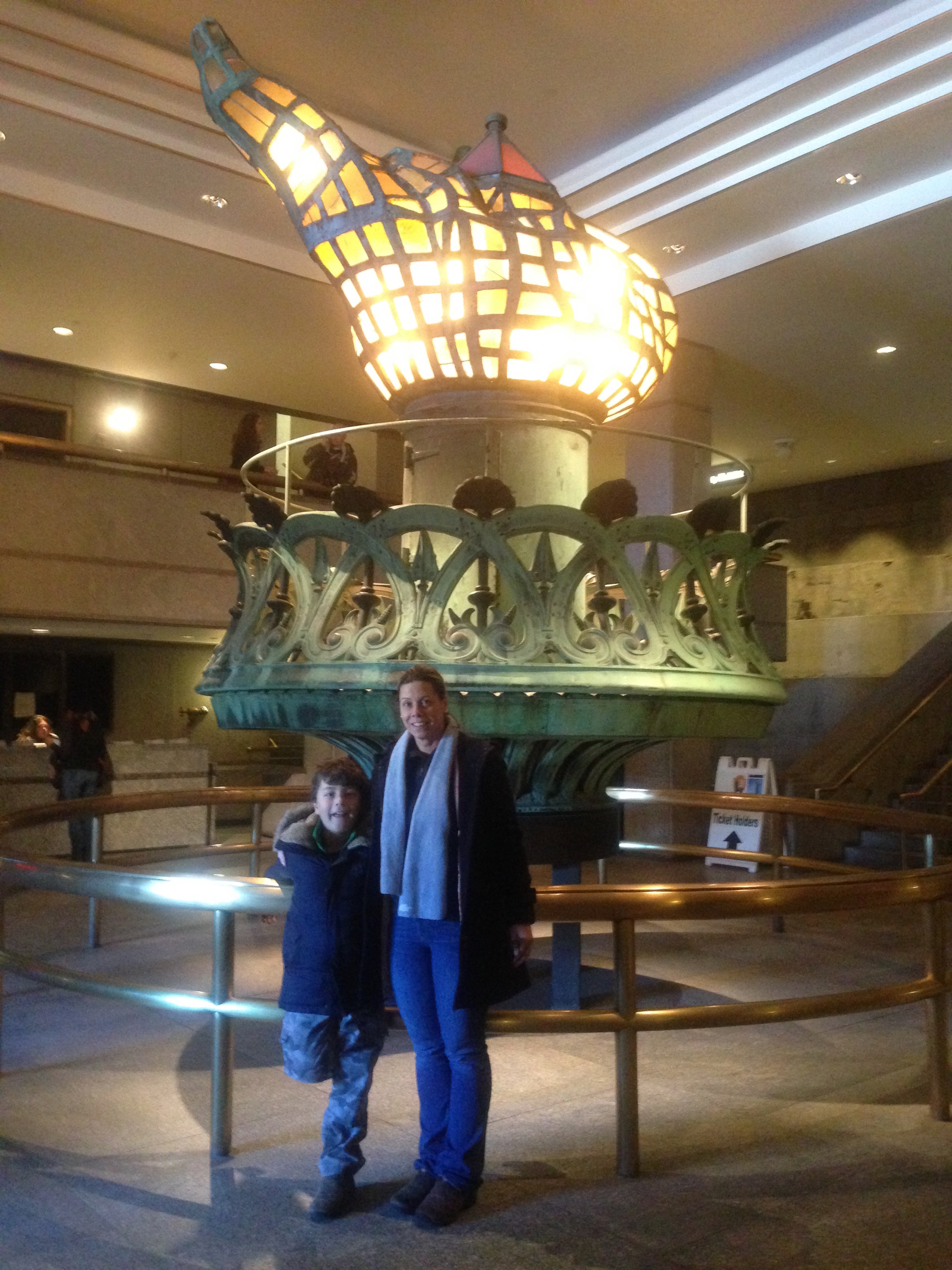 Inside the pedestal, mom and son with Statue of Liberty's flame