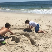 two boys making a sacn castle on the ocean beach at Sailor's Haven, Fire Island
