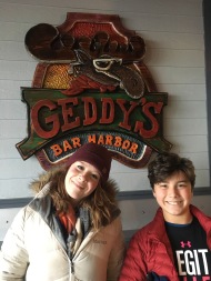 Kids pictured in front of Geddy's Restaurant sign in Bar Harbor, Maine