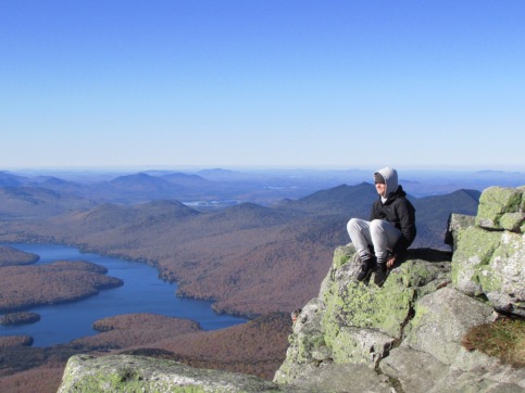 Sitting on the edge of Whiteface Mountain Summit, Adirondacks, New York