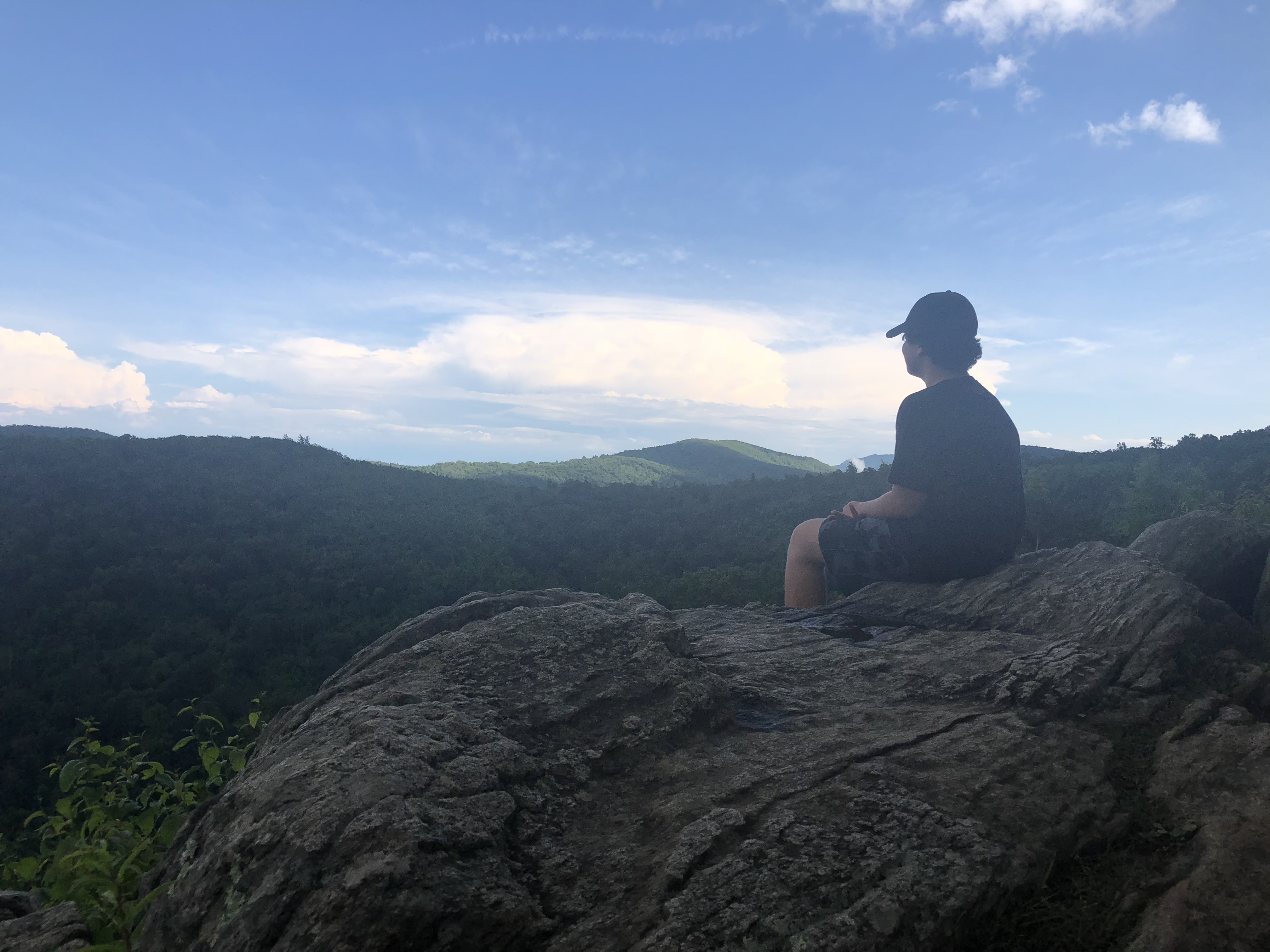 Boy sitting at Hazel Mountain Overlook, Skyline, Dr, Blue Ridge Mountains, VA